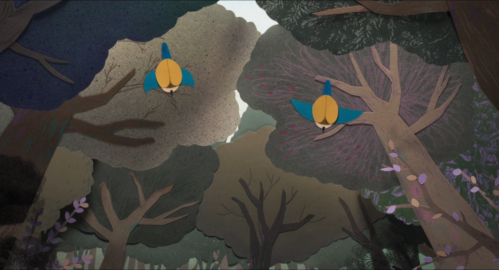 Blick von unten aus der Froschperspektive auf die beiden Blaumeisen, die durch dem Wald fliegen.